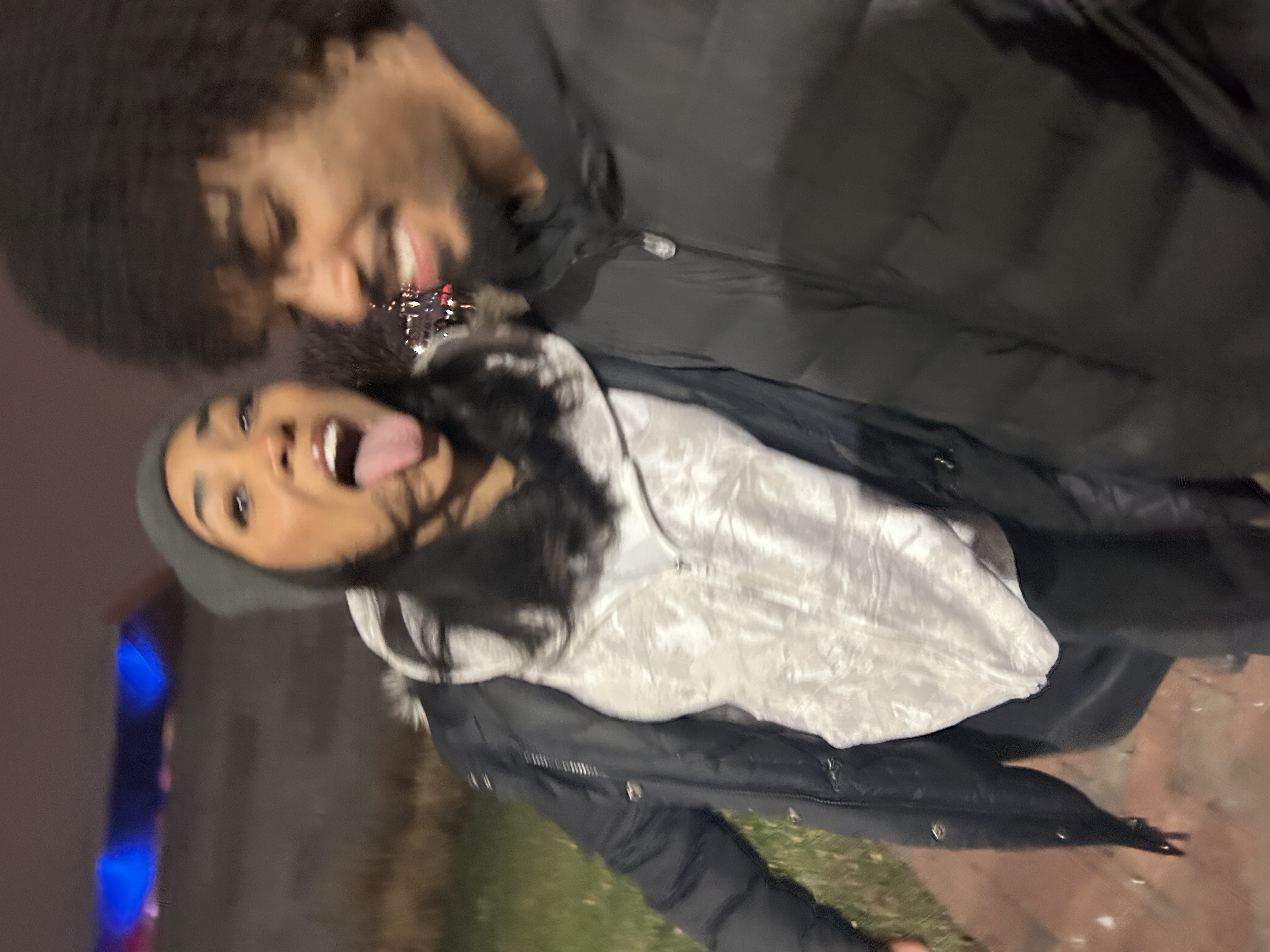 Jaden and his girlfriend making playful faces in a nighttime selfie