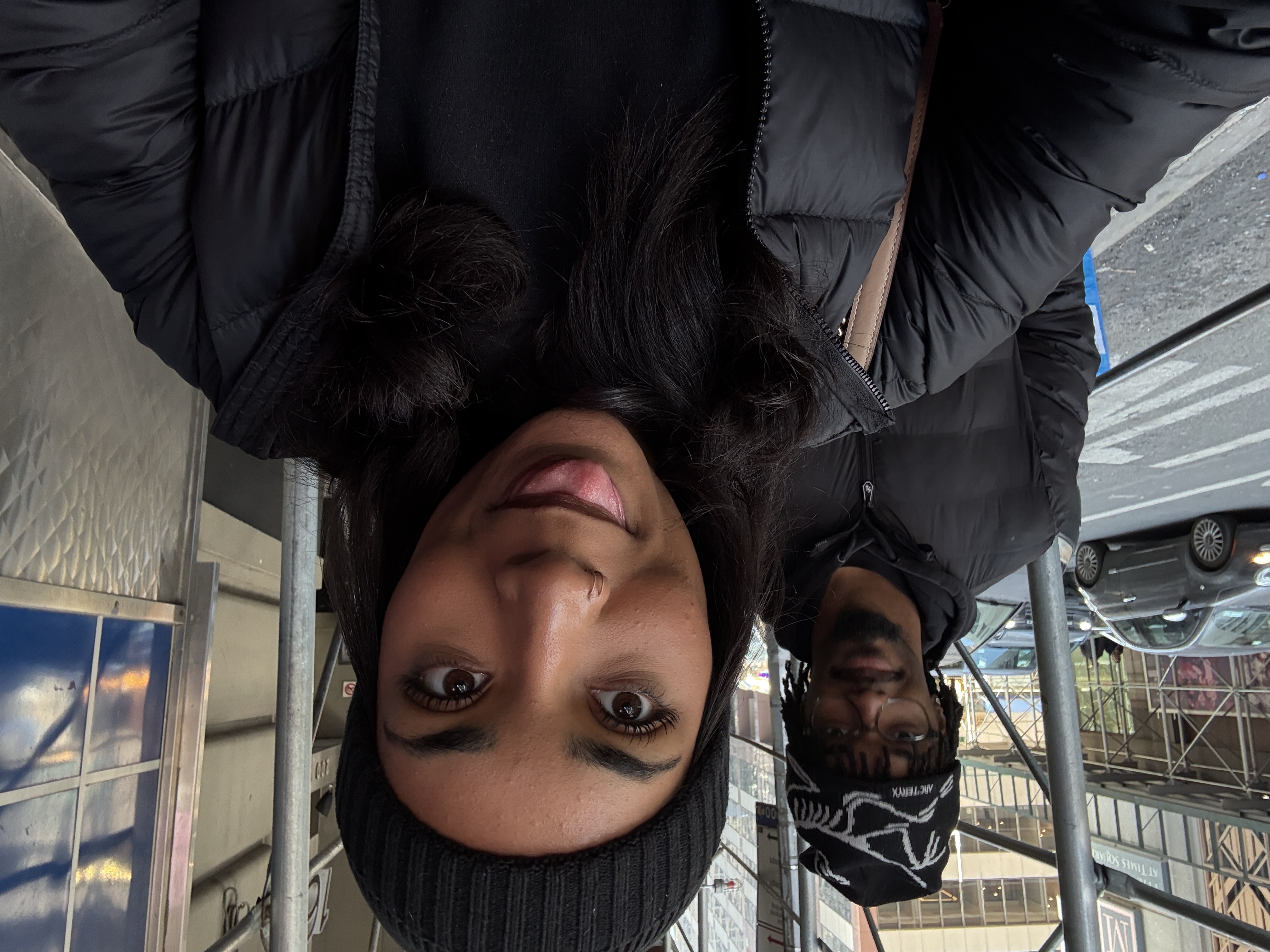 Jaden and his girlfriend taking a playful selfie on a city sidewalk