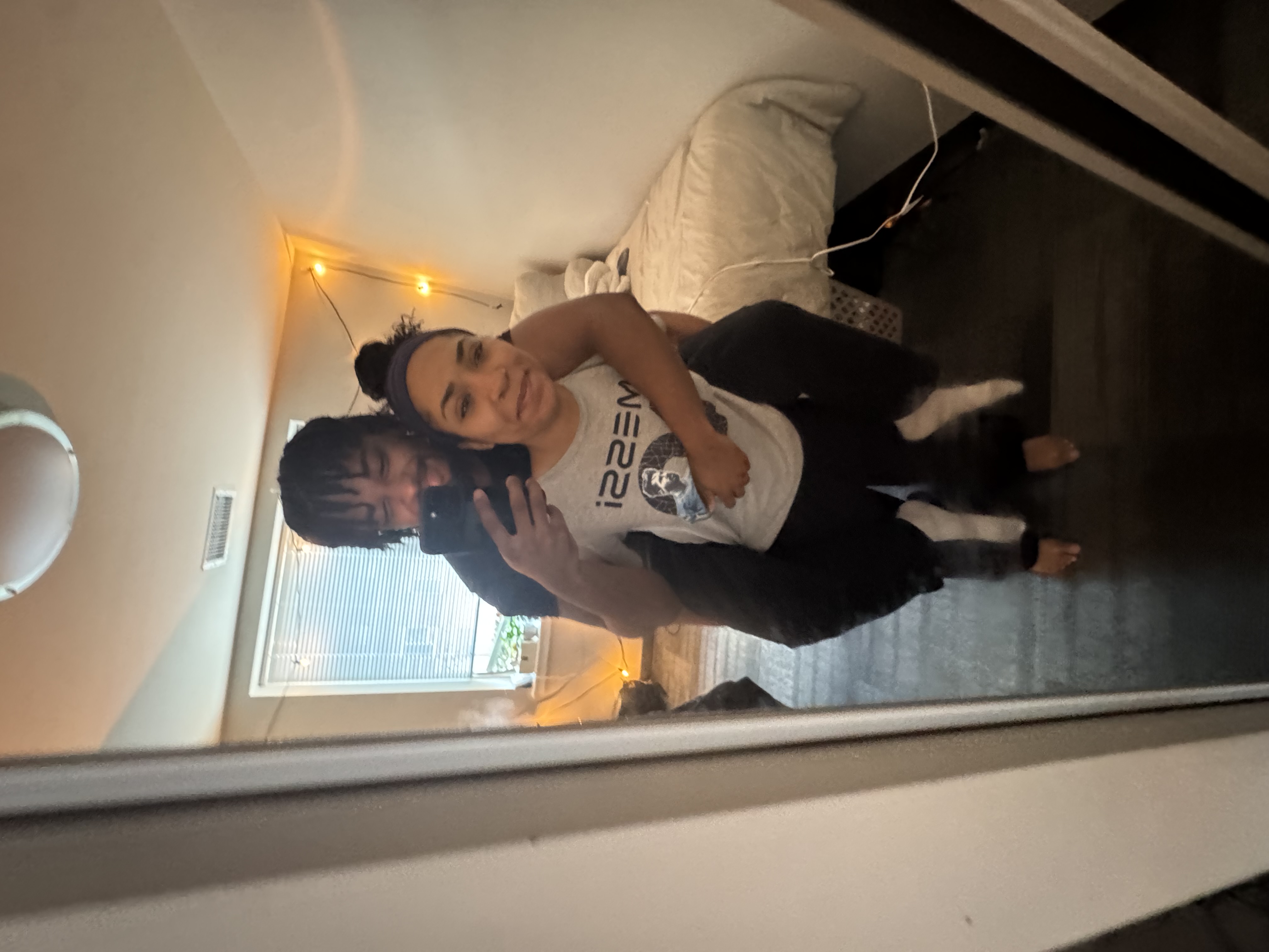 Jaden carrying his girlfriend in a playful mirror photo