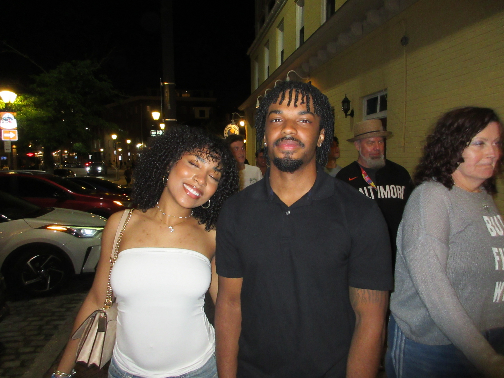 Jaden and his girlfriend dressed up and standing together outdoors at night