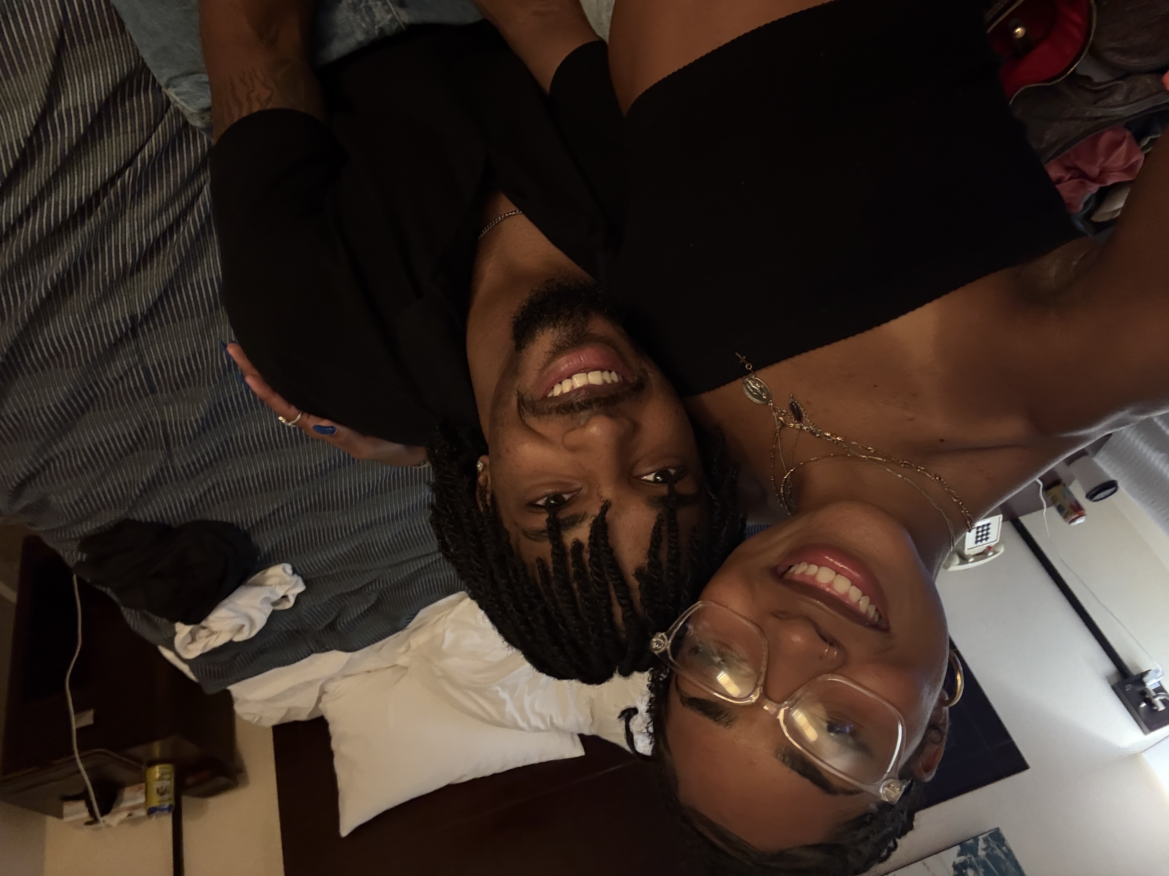 Jaden and his girlfriend smiling together in a hotel room