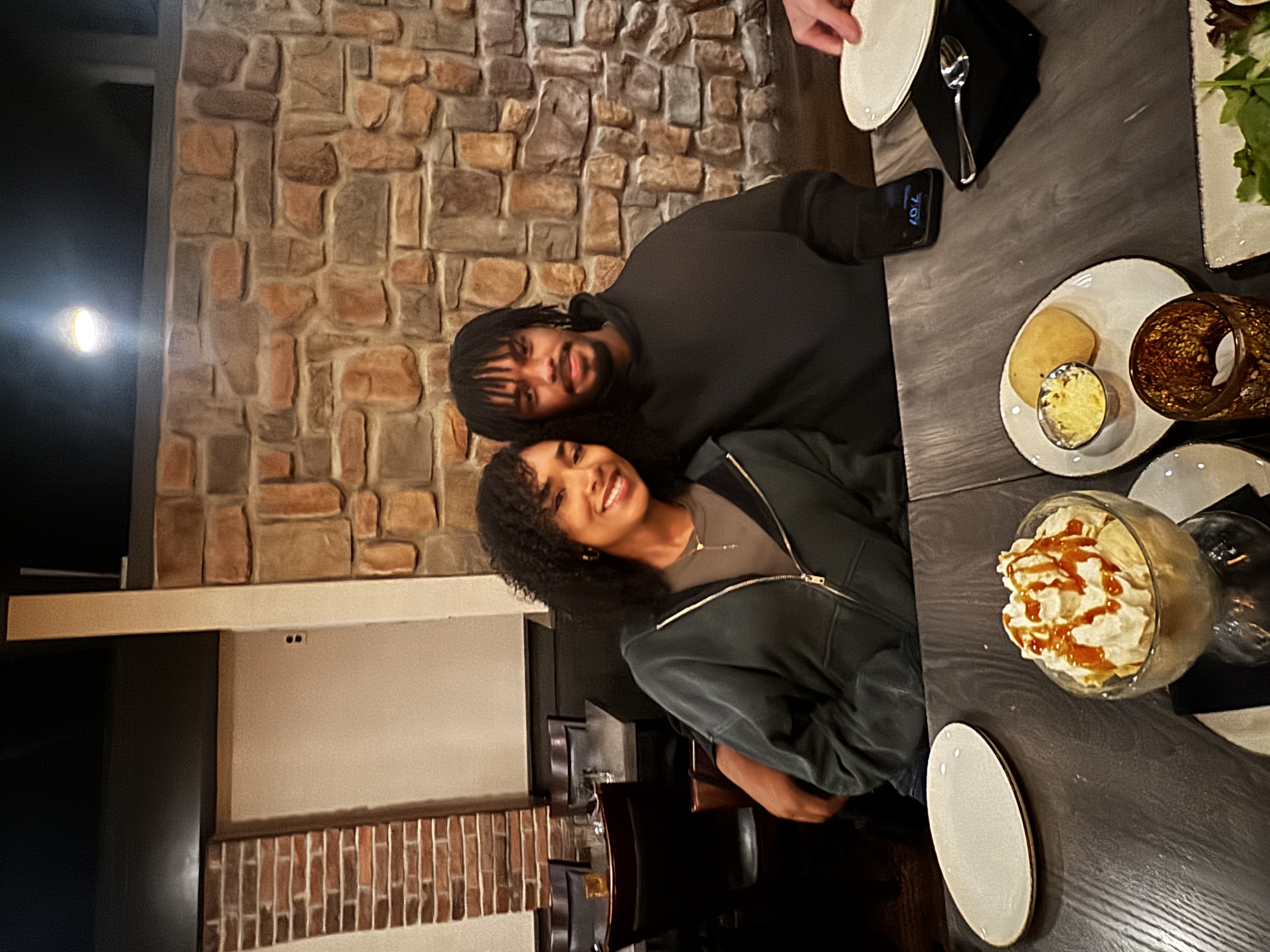 Jaden and his girlfriend sitting together at a restaurant
