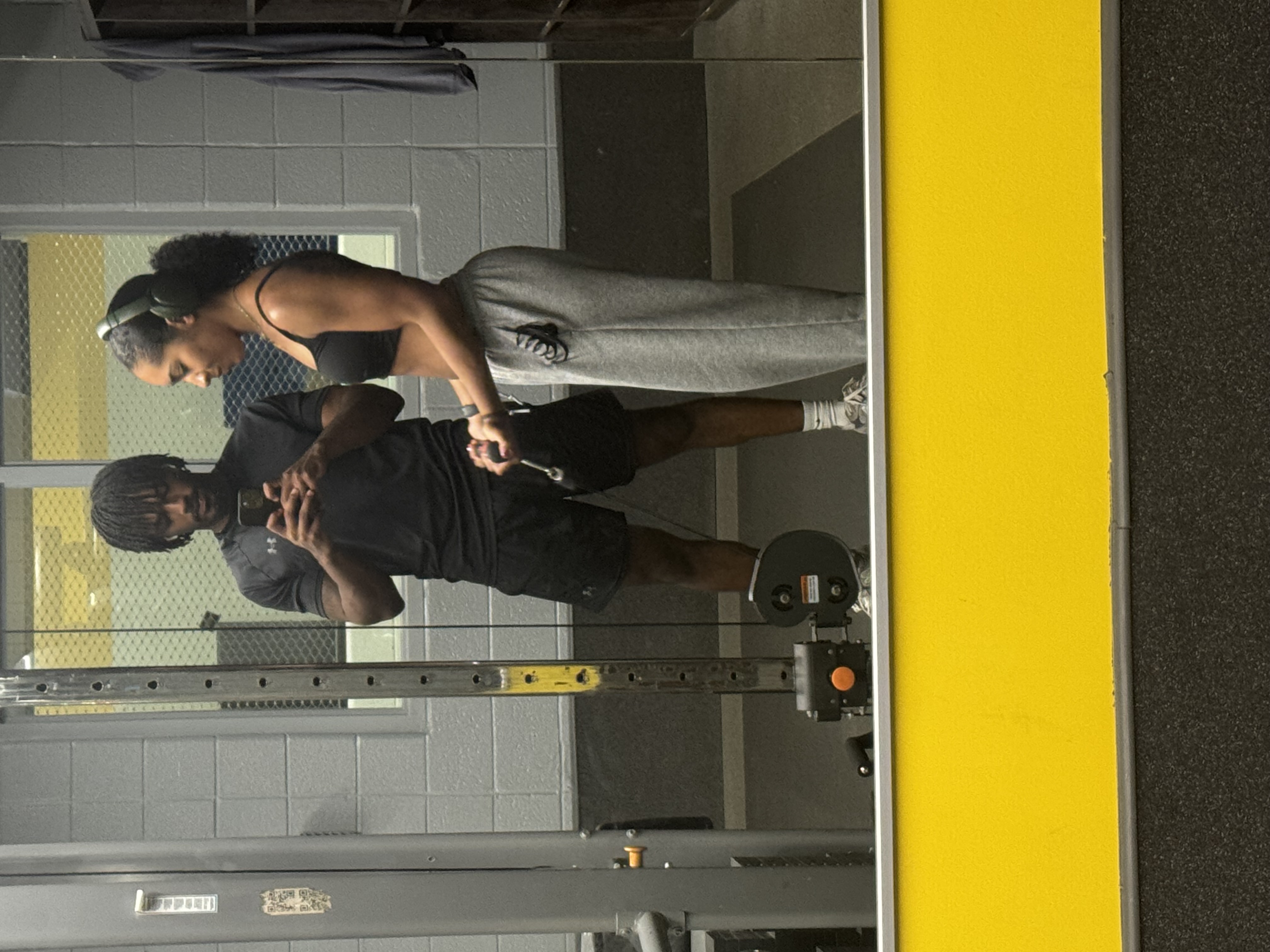 Jaden and his girlfriend taking a mirror photo at the gym
