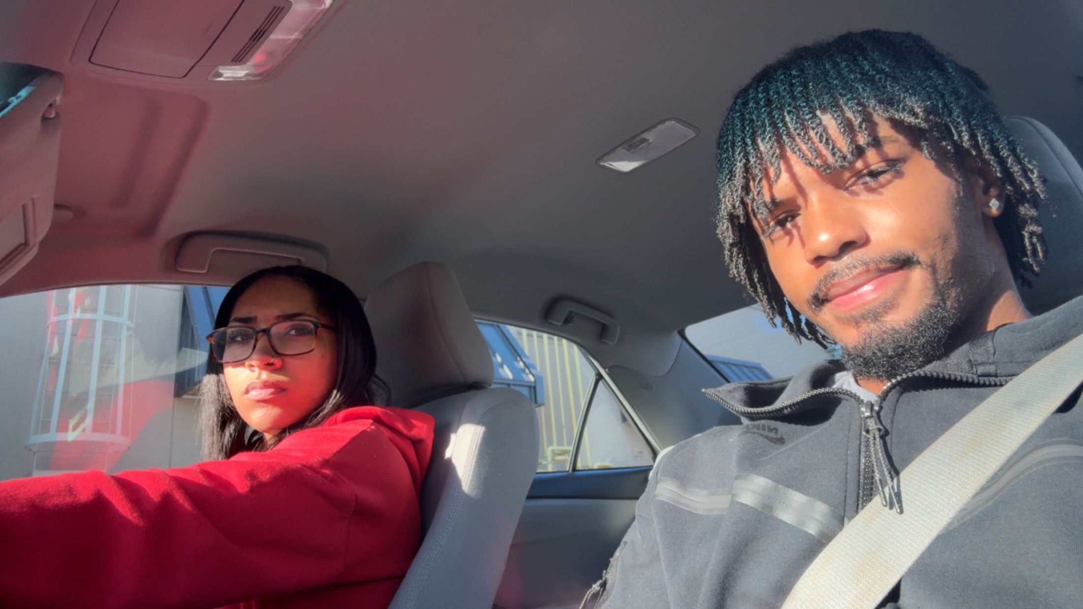 Jaden and his girlfriend taking a selfie together in a car